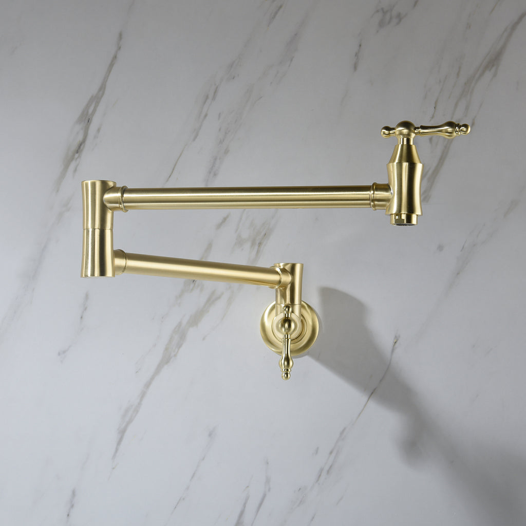 Gold kitchen faucet on a marble wall